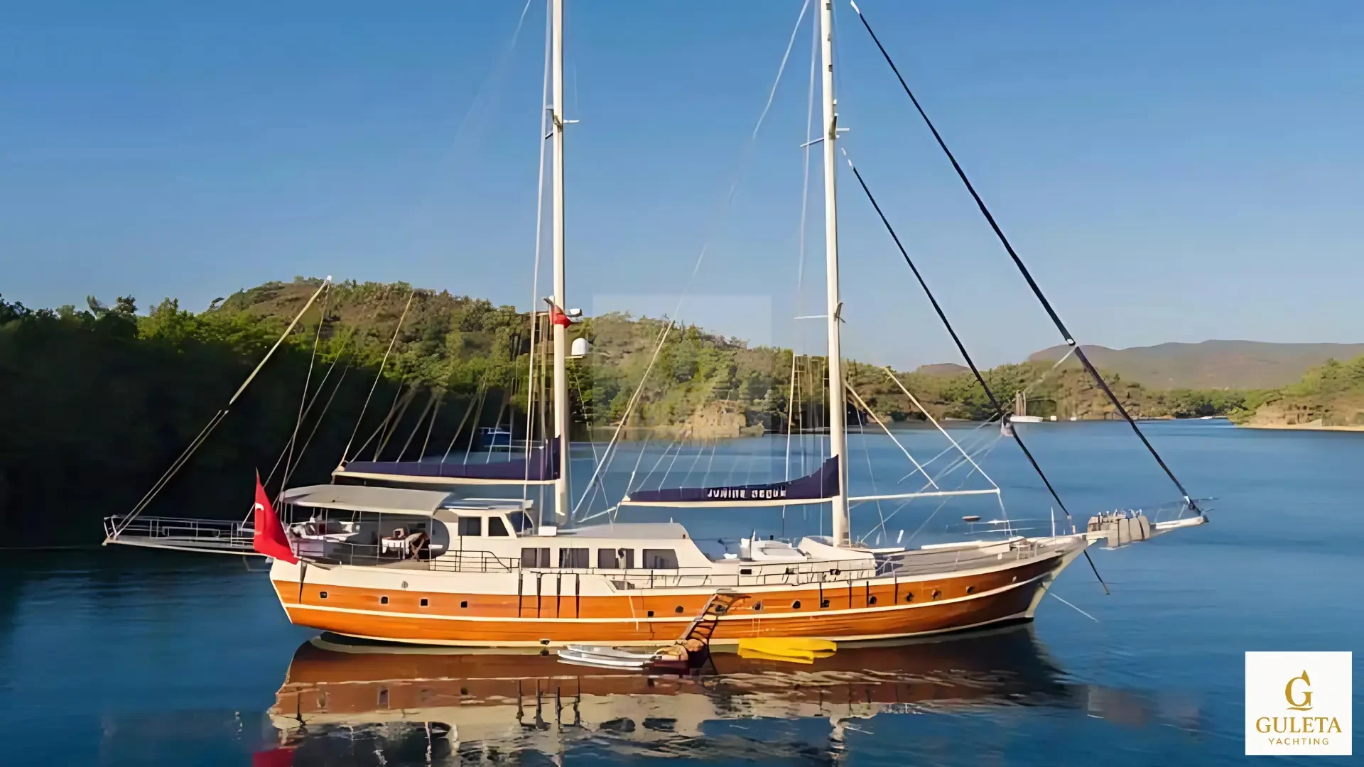 Junior Orçun Gulet anchored in the turquoise waters of Marmaris.Junior Orcun Gulet anchored in the bay of Marmaris Front view of Junior Orcun Gulet cruising under the sun Interior of Junior Orcun Gulet with comfortable cabins