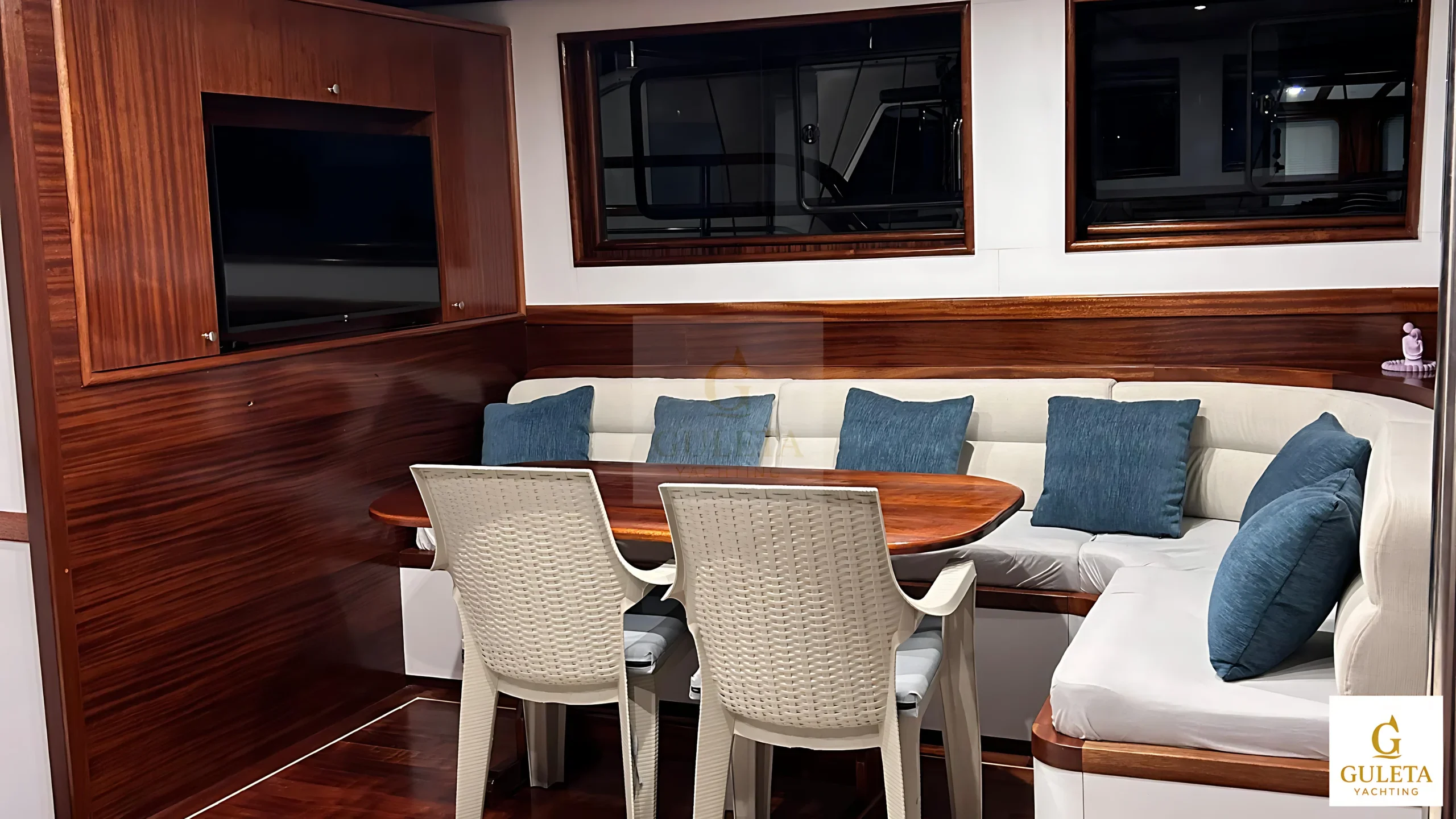 Lounge area inside the gulet with twin sofas and polished wood surroundings.