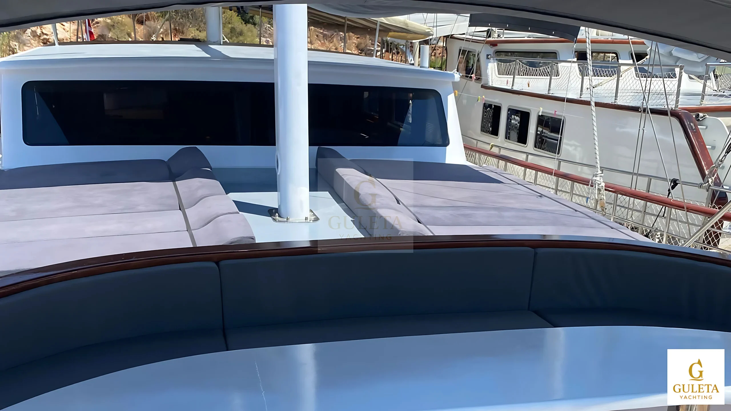 Rosa Del Mar Gulet bow view from a distance highlighting traditional design and spacious deck layout.