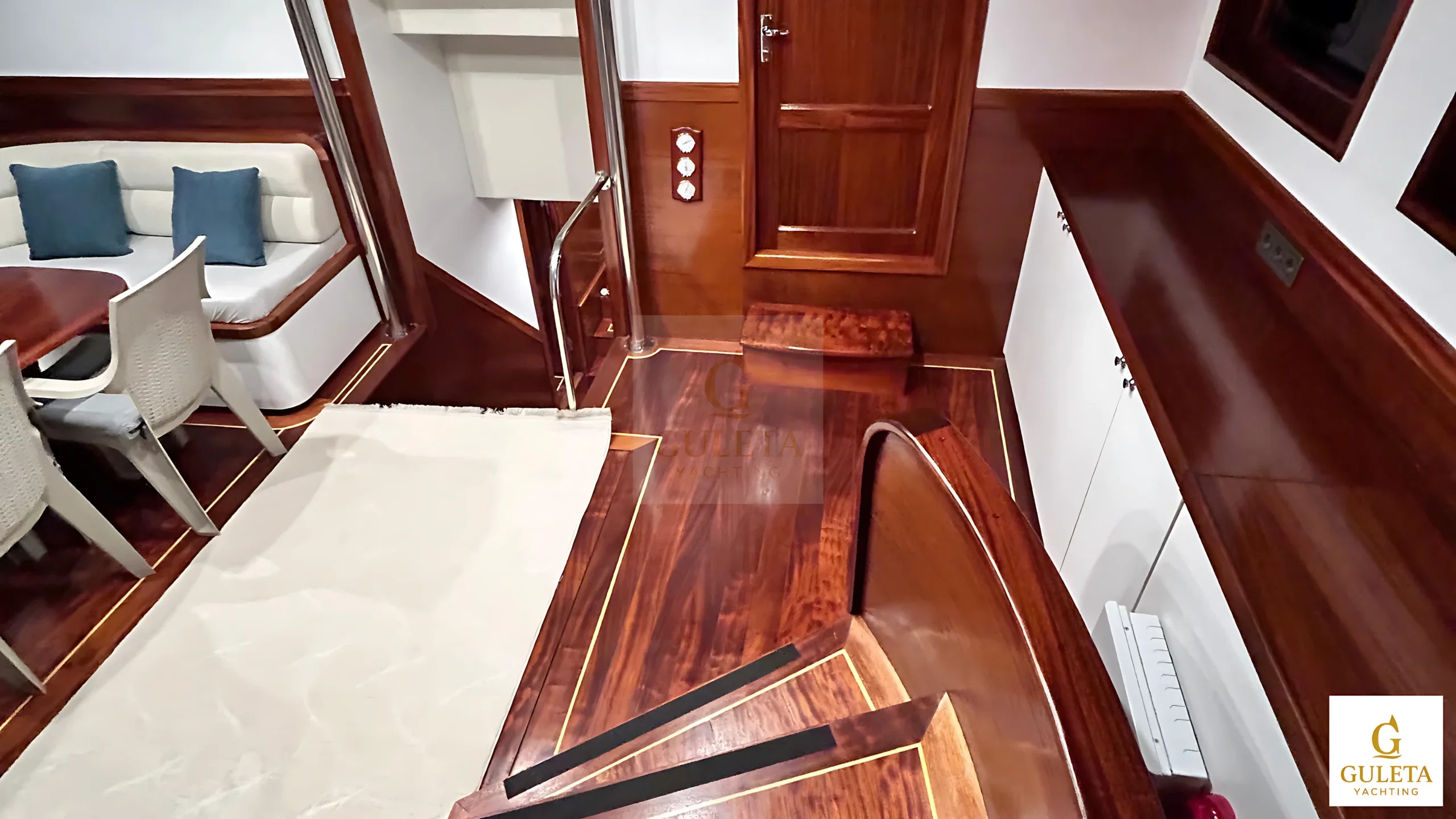 Stairway at the aft entrance of Sulyar Gulet, leading from the rear deck into the elegant interior.