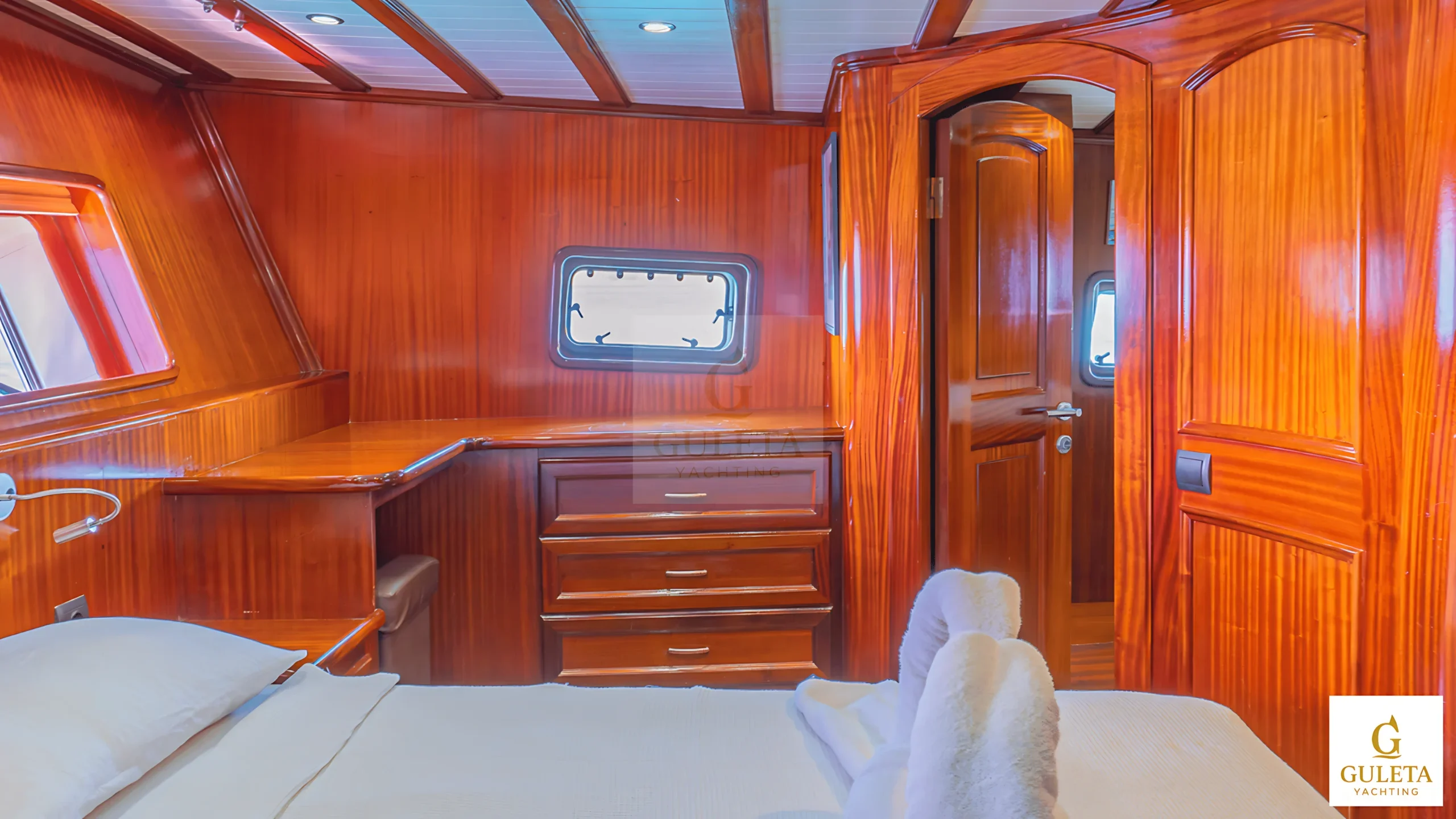 Lounge seating inside Avrasya Gulet’s cabin with cushioned bench and warm interior décor.