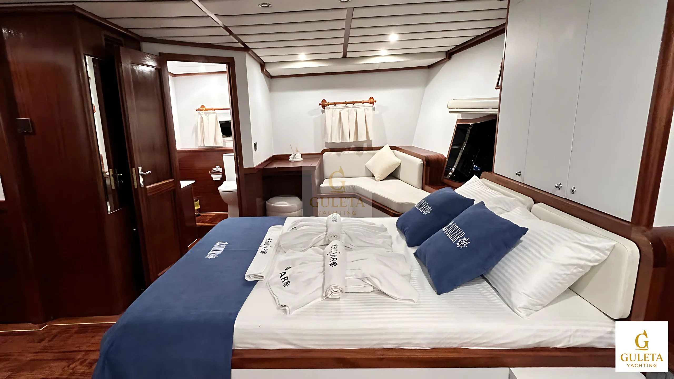 Side view of the Master Cabin on Sulyar Gulet, showcasing modern wood details and cozy design.