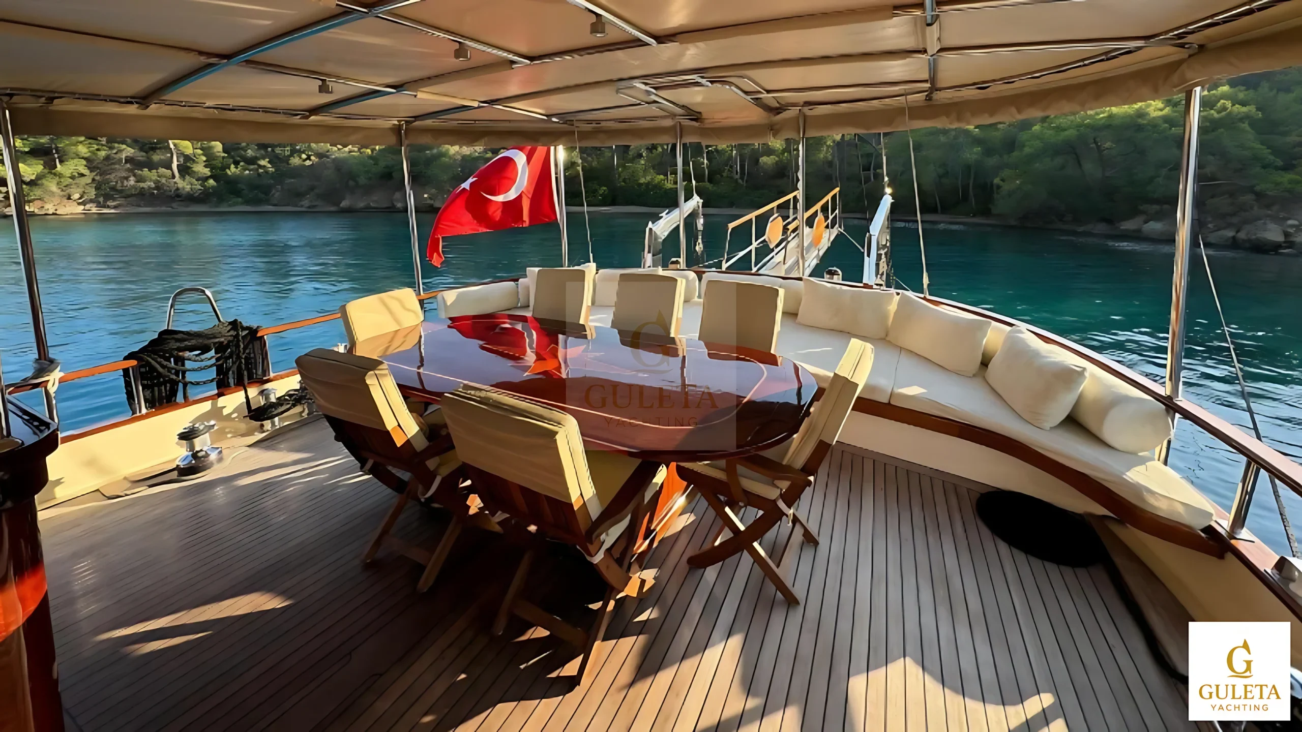 Sunrise 2 Gulet rear interior dining area with table and panoramic aft view.
