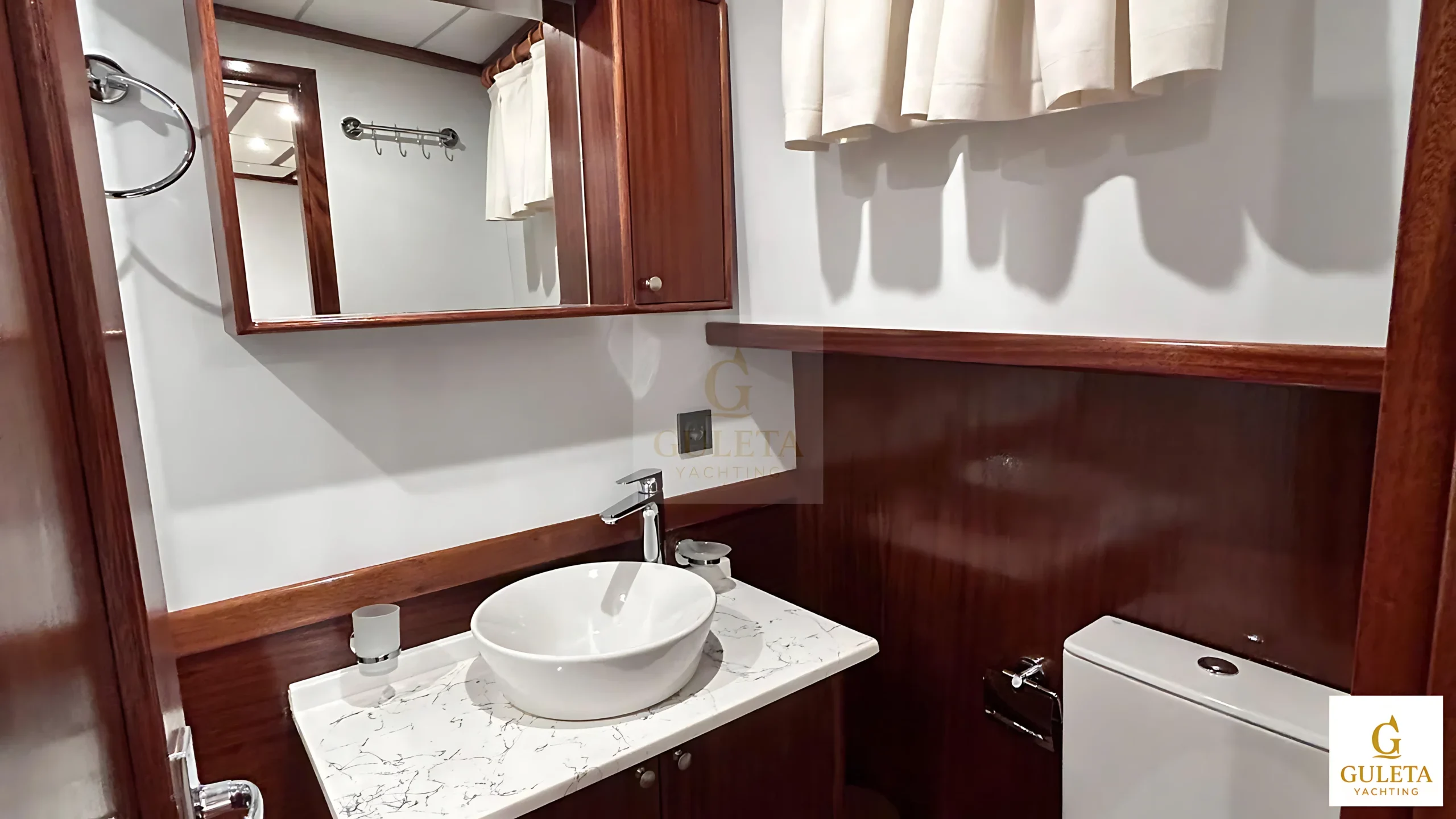 Compact bathroom and sink area featuring clean, minimalist design.