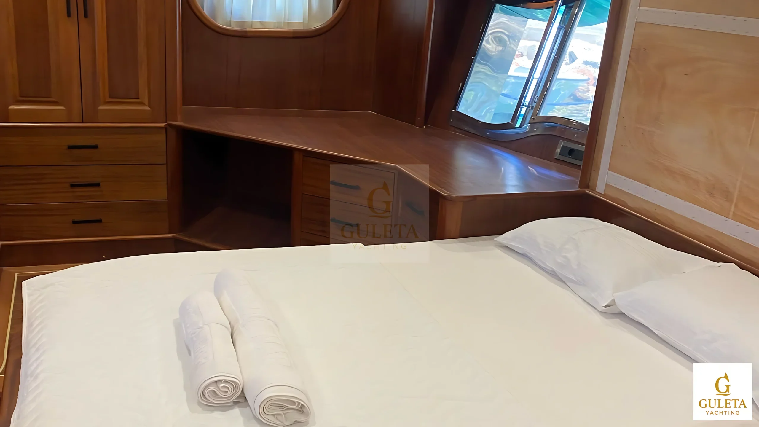 Rosa Del Mar Gulet side view of a second double cabin with elegant furnishing and storage space.