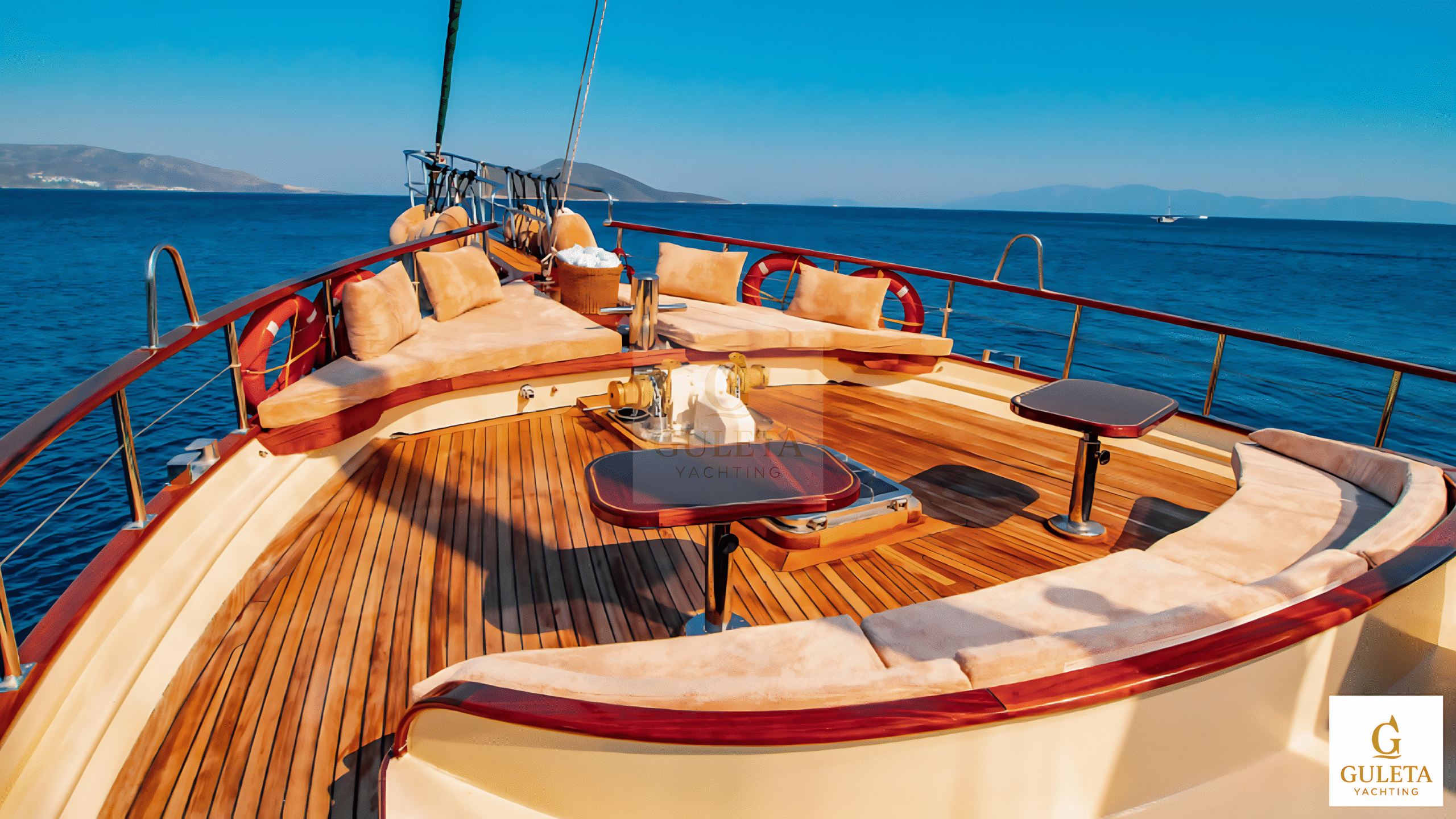 Sunrise 2 Gulet aft deck with cushioned seating area and al fresco dining table setup.