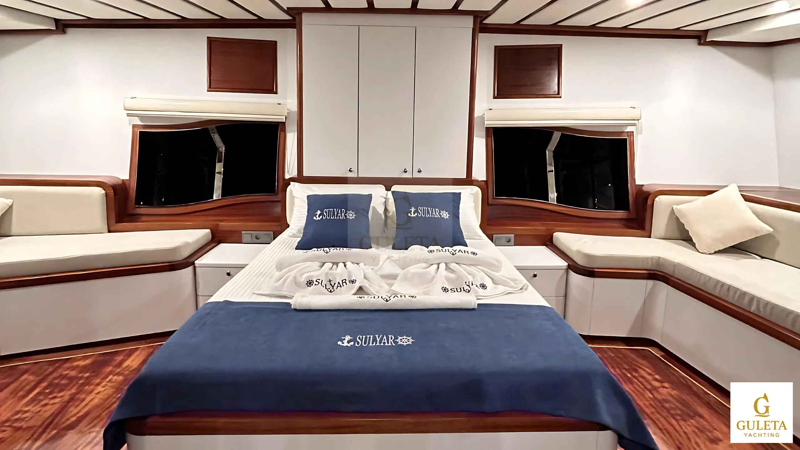 Second Master Cabin with double bed, soft lighting, and elegant woodwork.