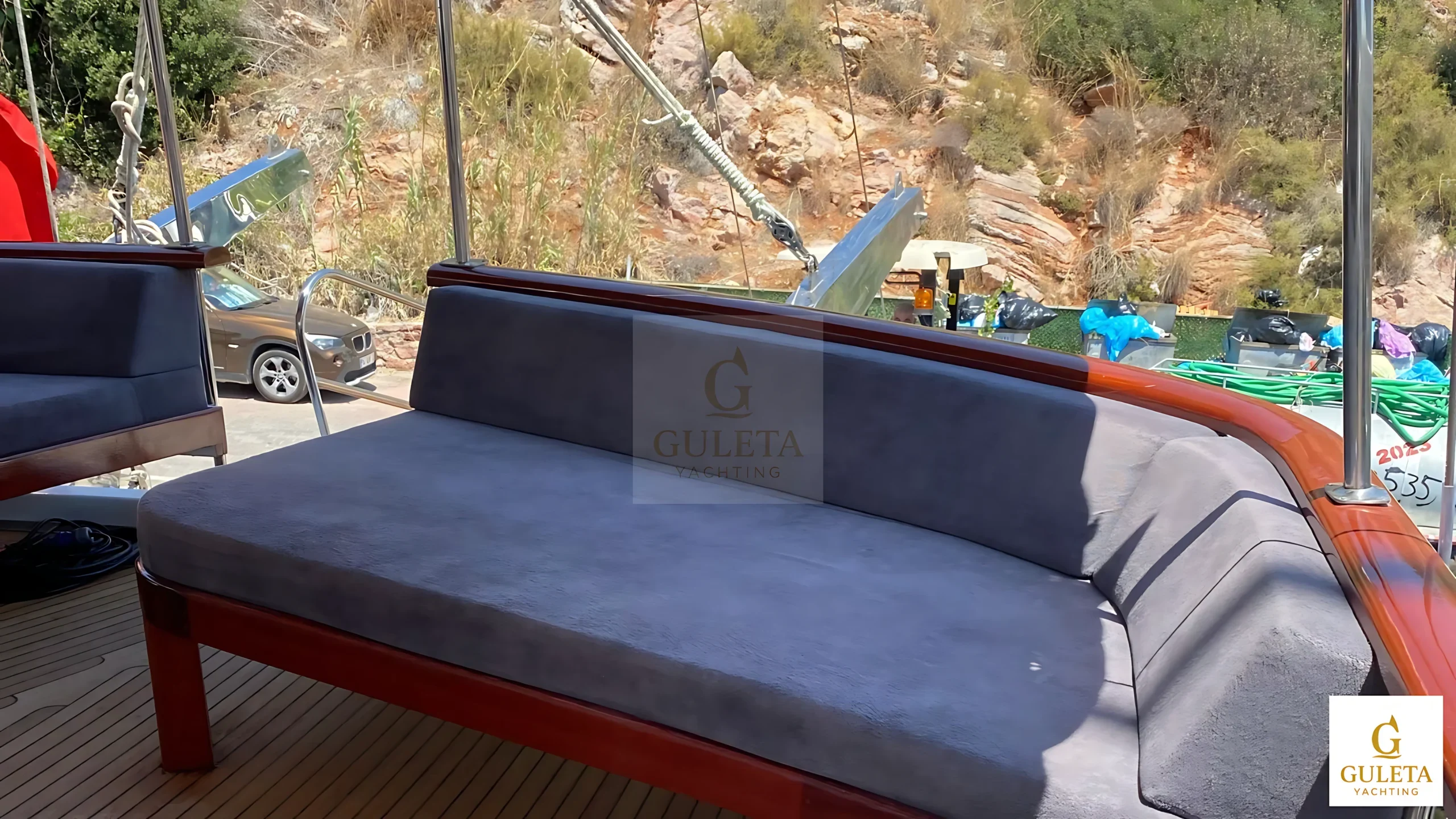 Rosa Del Mar Gulet aft deck view with comfortable sunbeds for relaxing and enjoying panoramic sea views.
