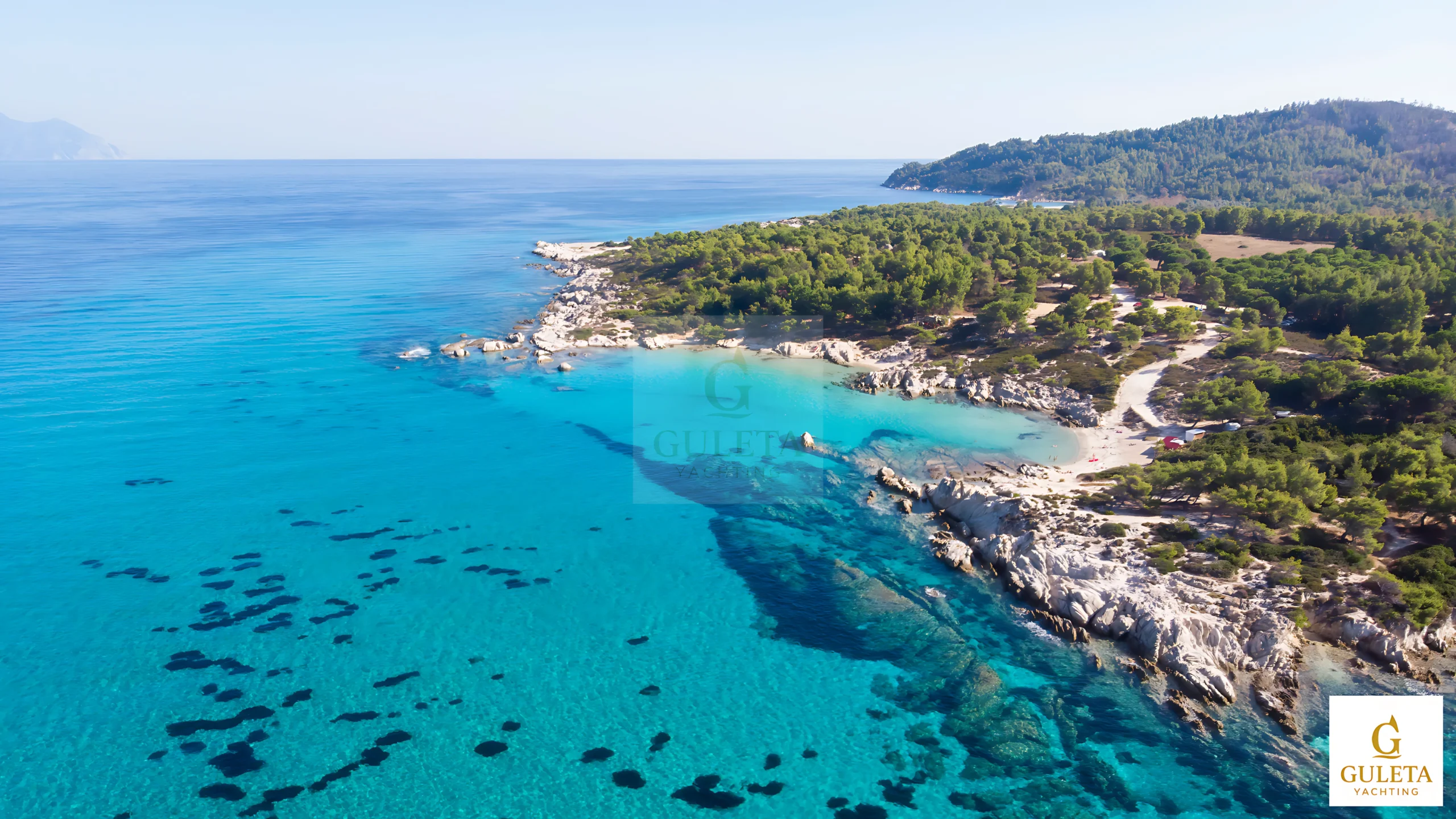 Turquoise waters and green hills along the Gokova gulet yacht charter route to Çökertme Bay.
