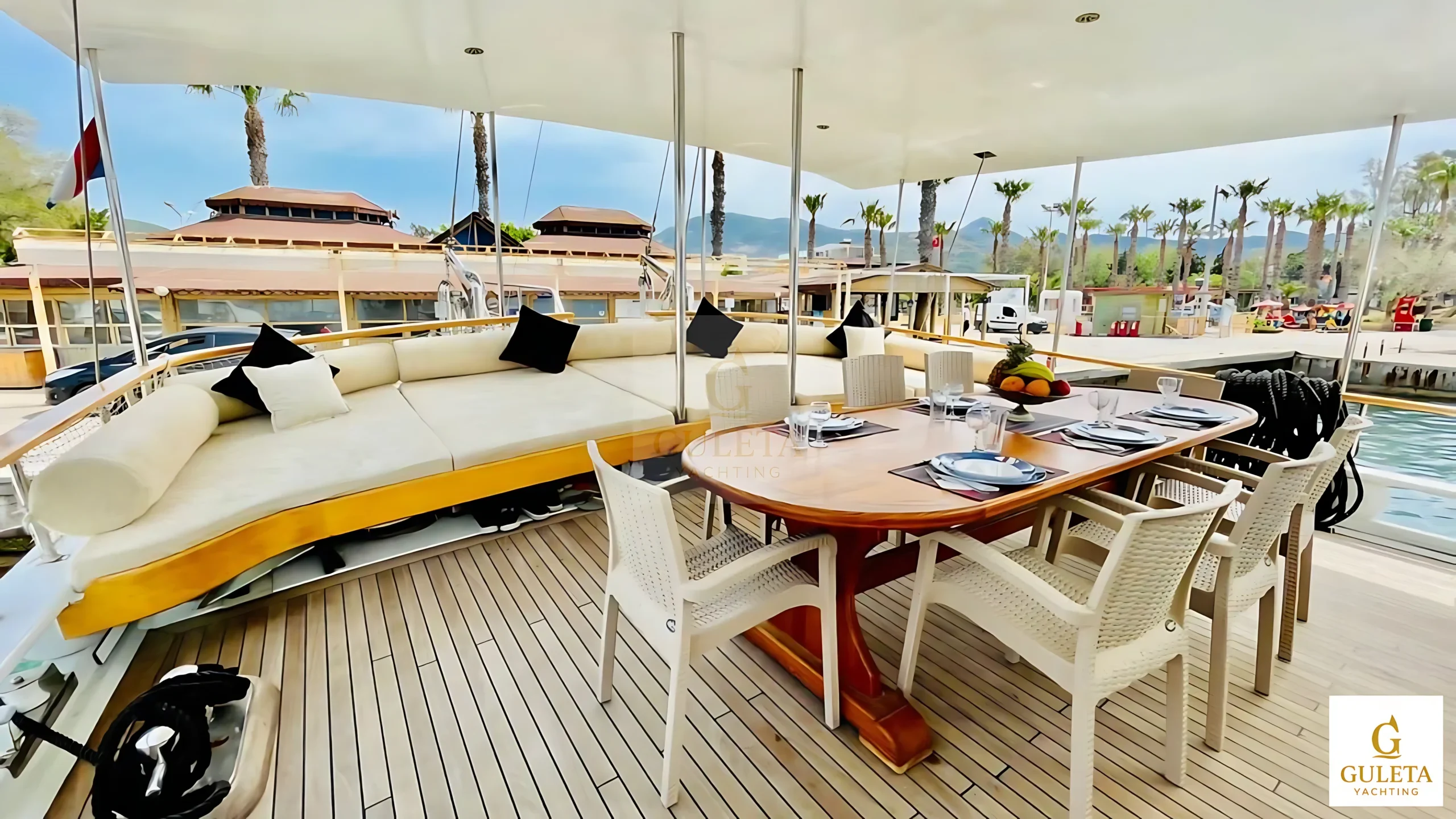 Dining table and cushions on the aft deck of Pam Due Gulet