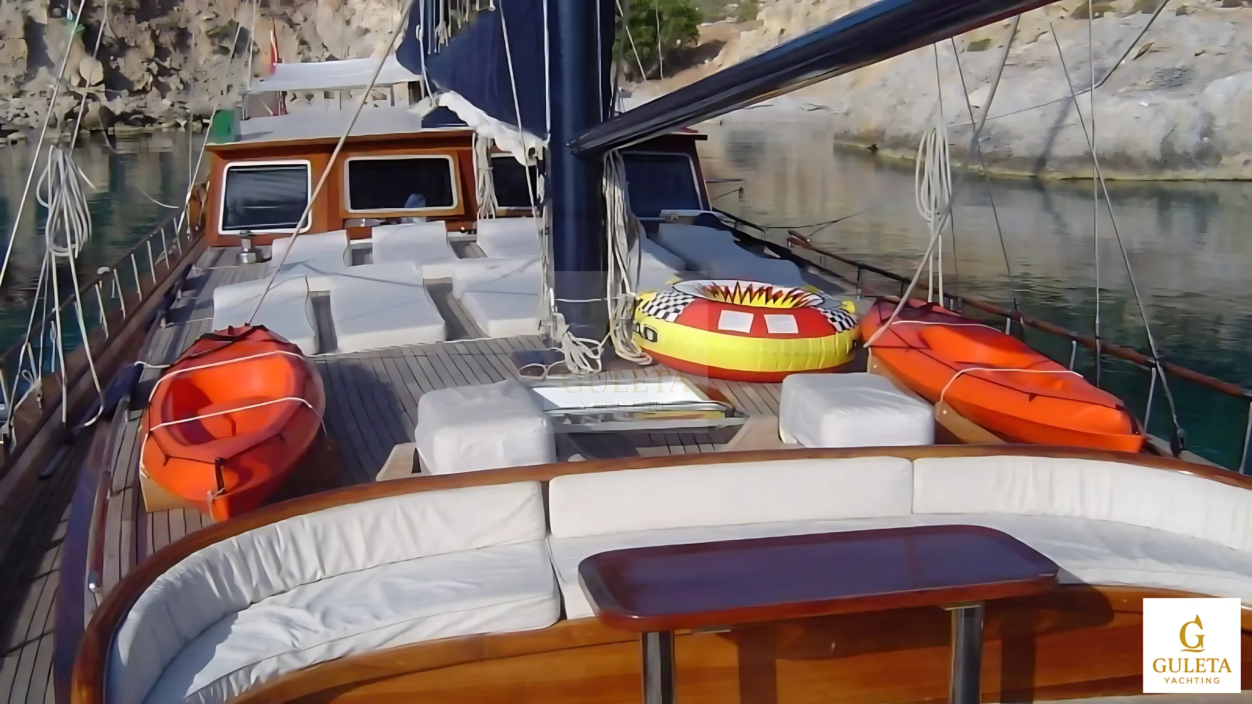Bow view of Kaptan Şevket Gulet yacht anchored in crystal-clear waters.